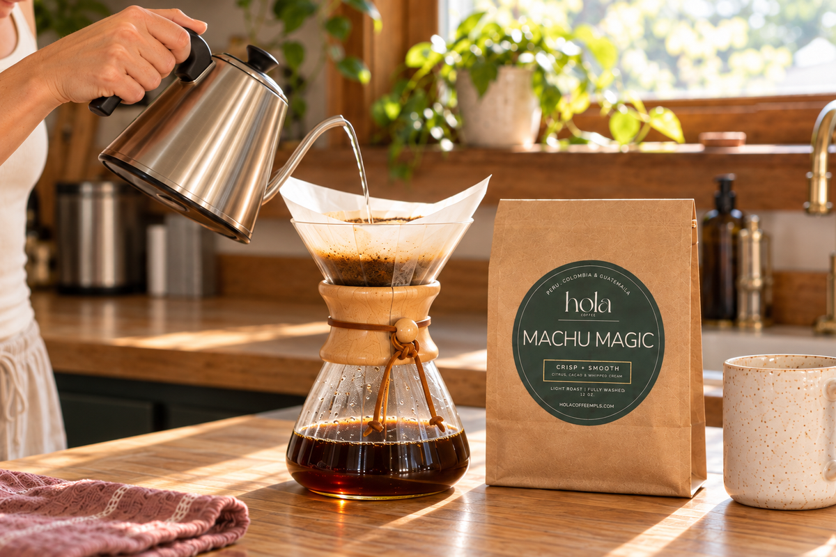 Pour-over coffee in a Chemex beside a 12oz Machu Magic bag.