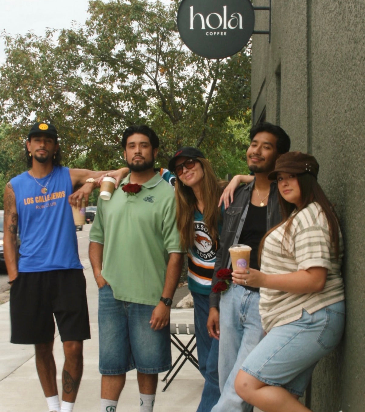 A group of friends gathered outside Hola café